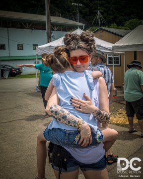 A very tired DelFest child being carried around by a loving mother.