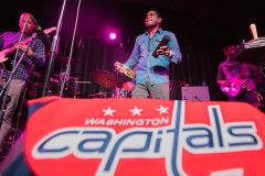 Backbeat Underground performs with a Capitals Jersey on a monitor