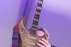 Nick Forester of eTown Radio  holds aloft Billy Strings grandfather's guitar