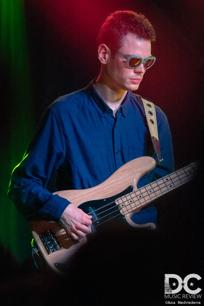 Alex's bass player wearing the glasses thrown onto the stage
