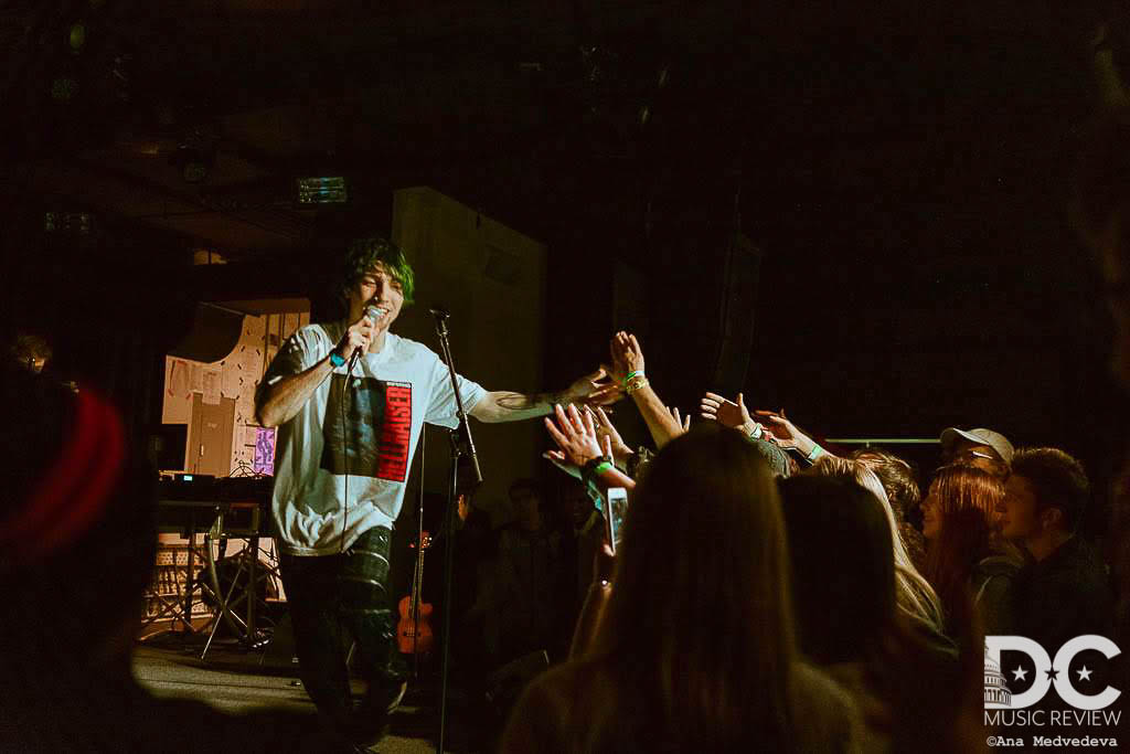 Guardin runs across stage high fiving his fans