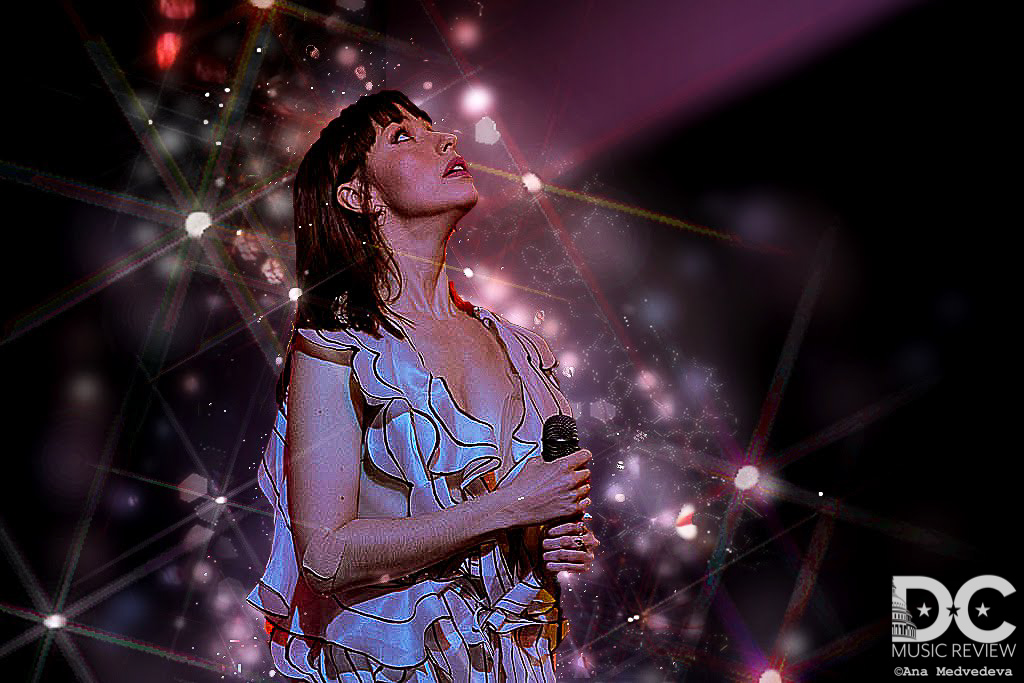 Kimbra looking up in the midst of her performance 