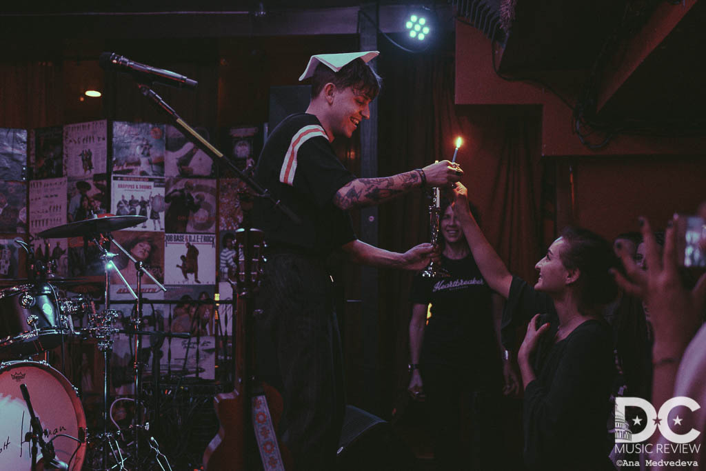 Scott Helman lighting a menorah with a fan