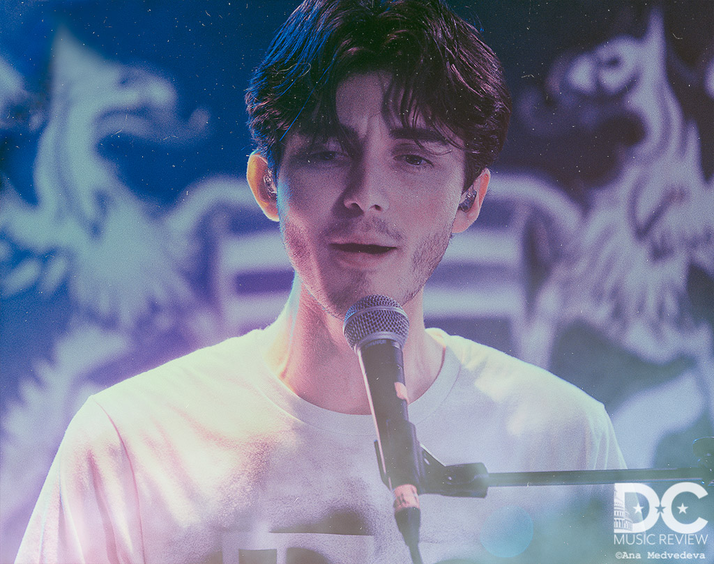 Greyson Chance sitting at his piano in the midst of his performance