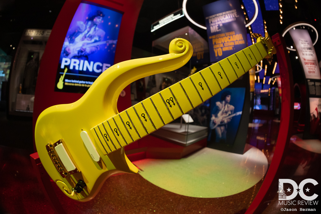A replica of Prince's "Yellow Cloud" guitar with the real one just behind under glass.