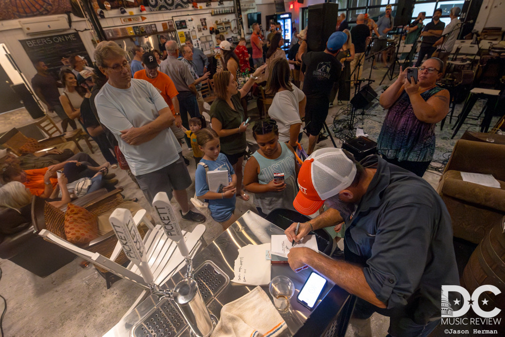 Tim Newby signs his latest book for a long line of fans