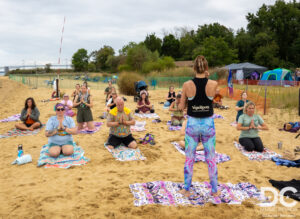 Yoga on the beach with the festival in full swing