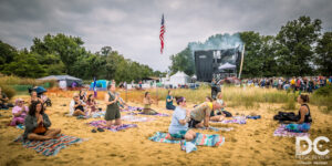 Yoga on the beach with the festival in full swing