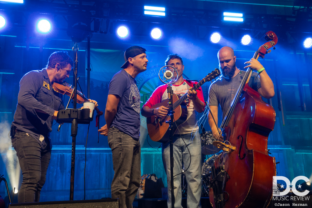 Scythian and Jonny Rees perform in front of an old-time mic