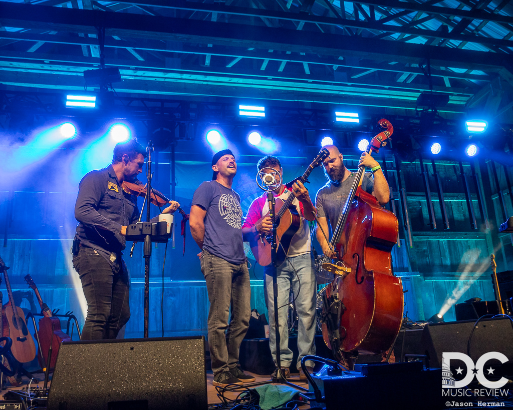 Scythian and Jonny Rees perform in front of an old-time mic